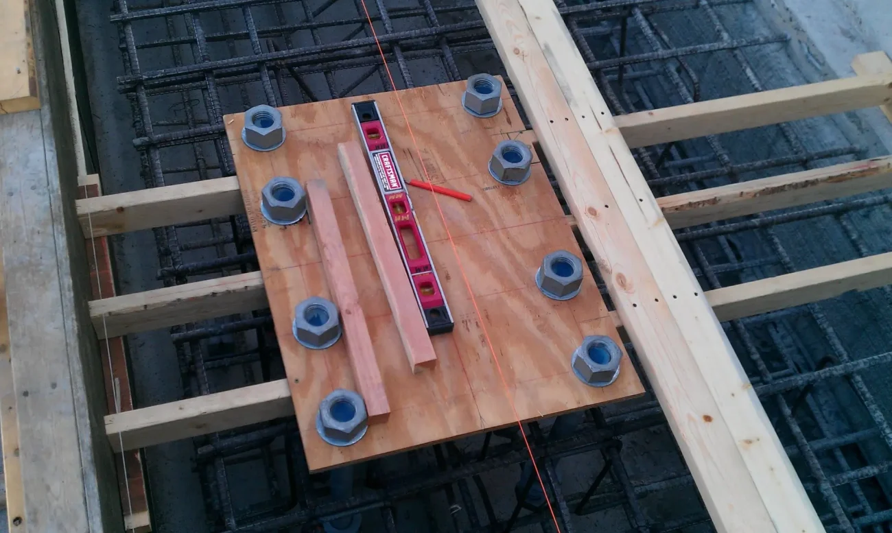 Anchor bolt template on rebar mat before concrete foundation pour